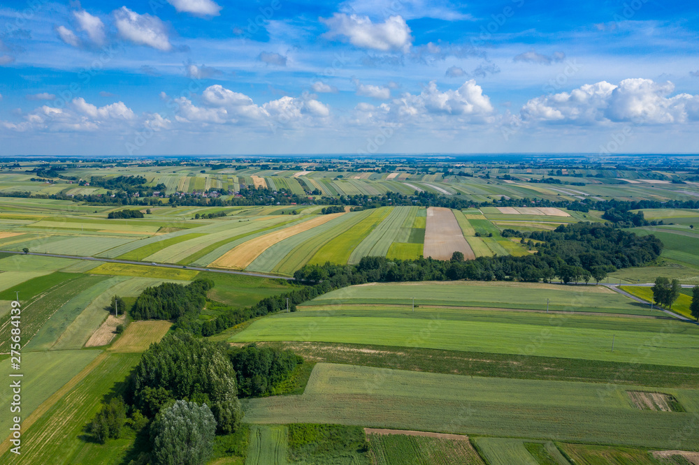 Aerial view of farmlands and mountains in rural Poland seen from drone. Summer time.