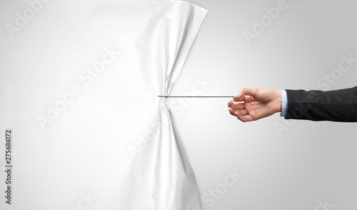 Canvas Print hand pulling white paper curtain, changing scene concept