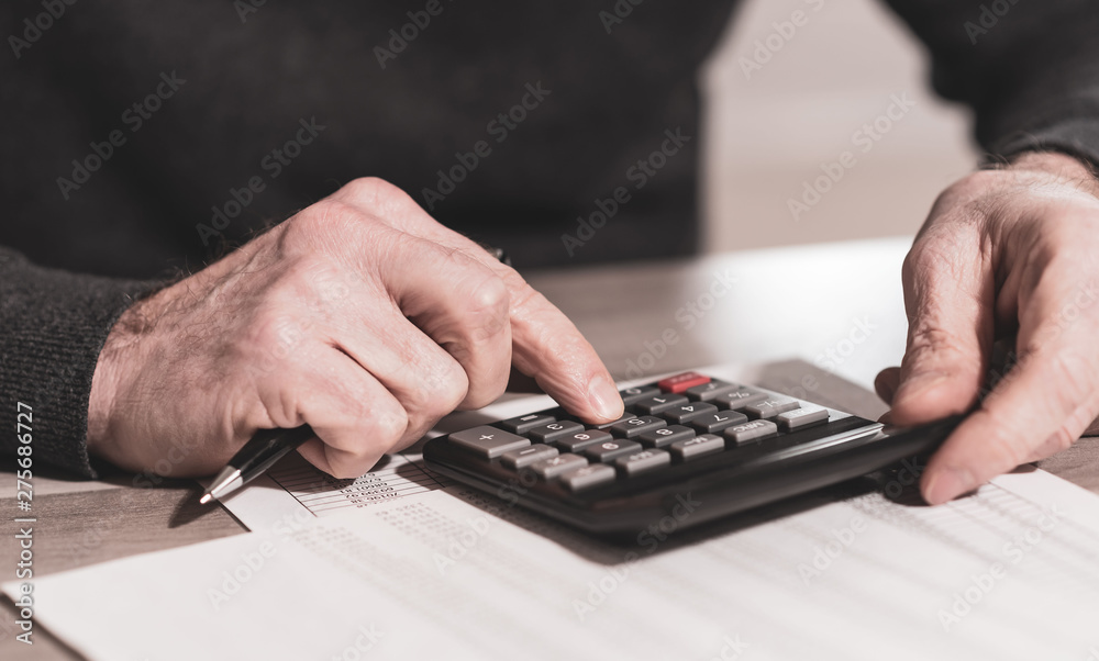 Hand using calculator, accounting concept - obrazy, fototapety, plakaty 