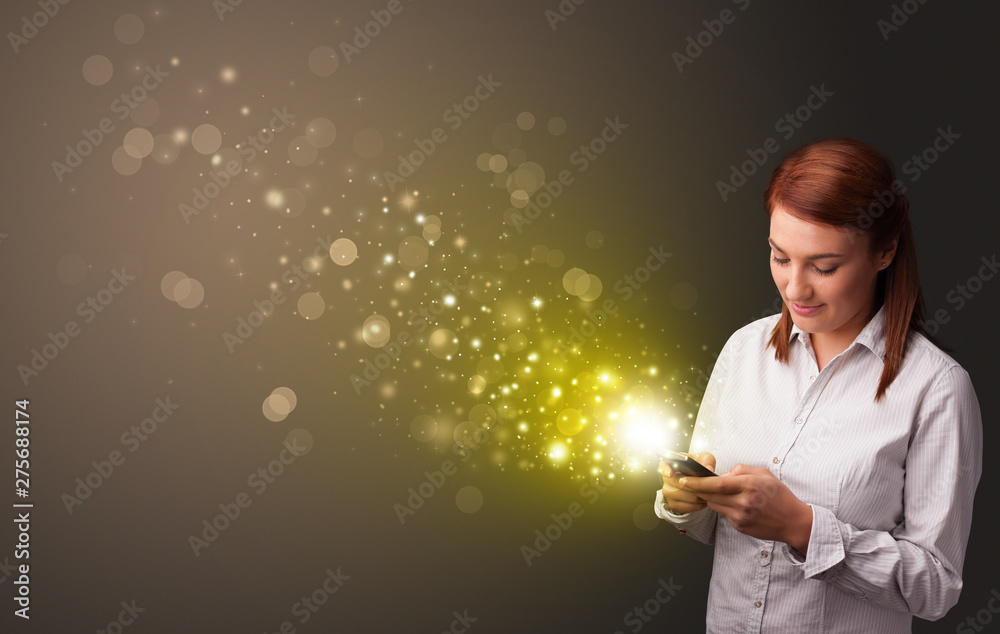 Person using phone with gold sparkling concept
Person using phone with gold sparkling concept