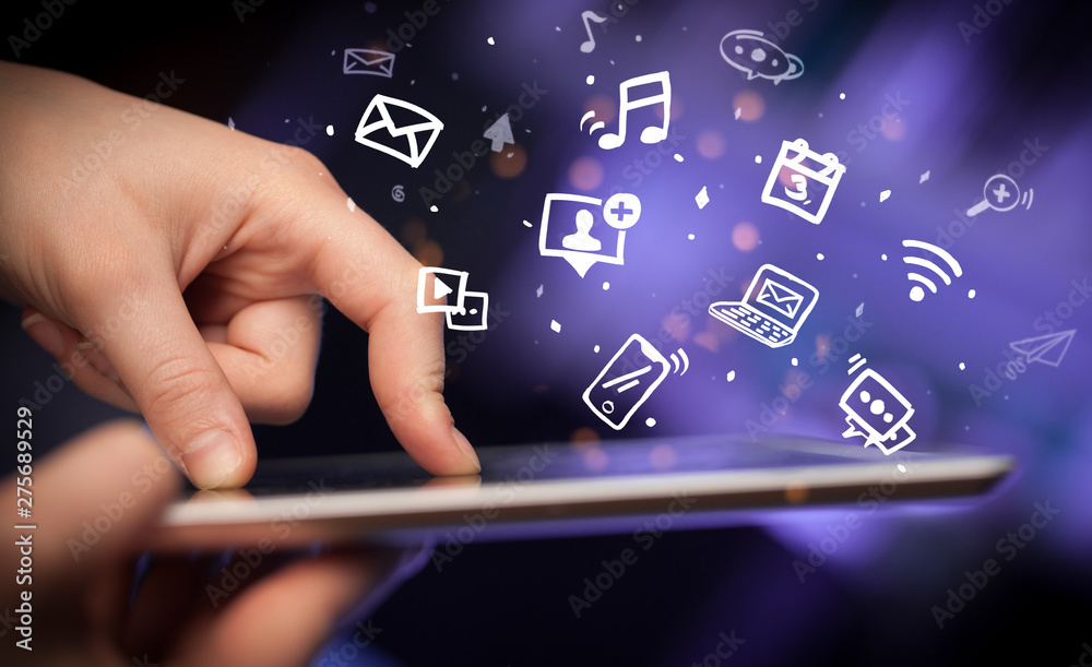 Hand holding tablet with drawn multimedia and application icons
