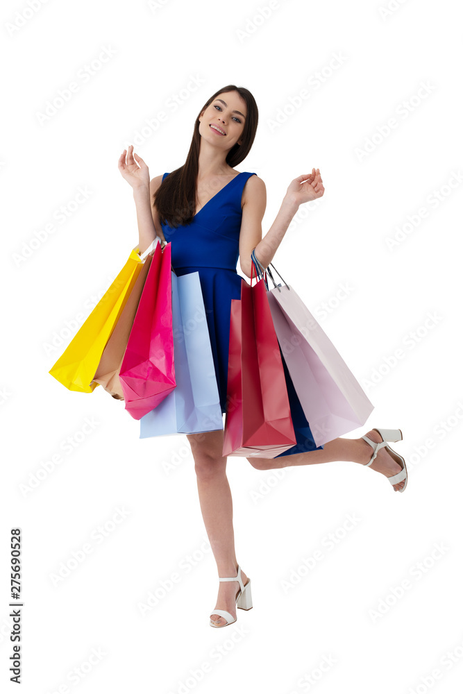 Happy woman with shopping bags in hand. Isolated on white background.