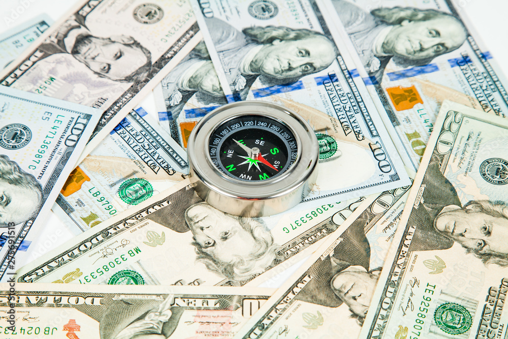 international compass in dollars in the background. international compass in dollars in the background.