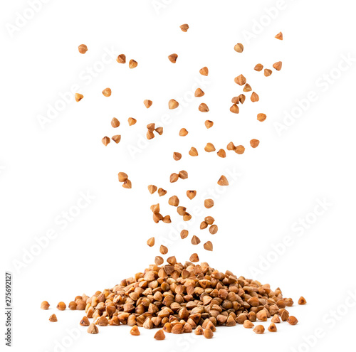 Bild auf Leinwand Buckwheat seeds fall in a pile on a white, isolated.