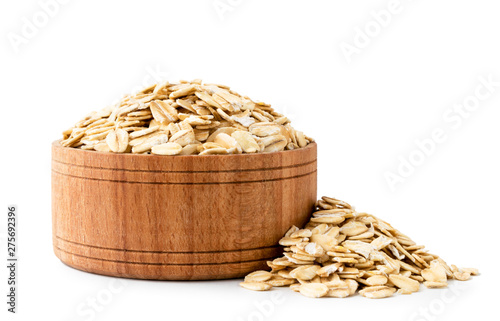 Oatmeal in a wooden plate close-up on a white background.