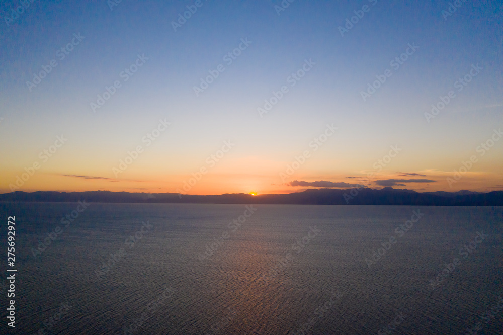 Seascape with islands at sunset. Evening Scene Night is Coming. Evening sun behind the islands.