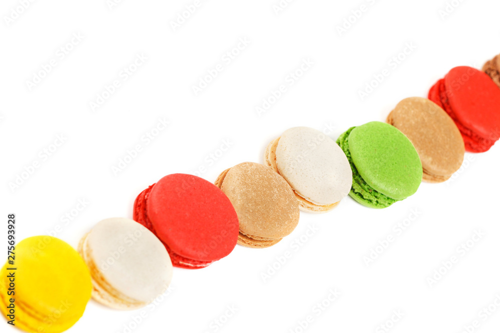 Obraz premium Macaroons on a white background. A row of colored macaroons. Diagonal composition.