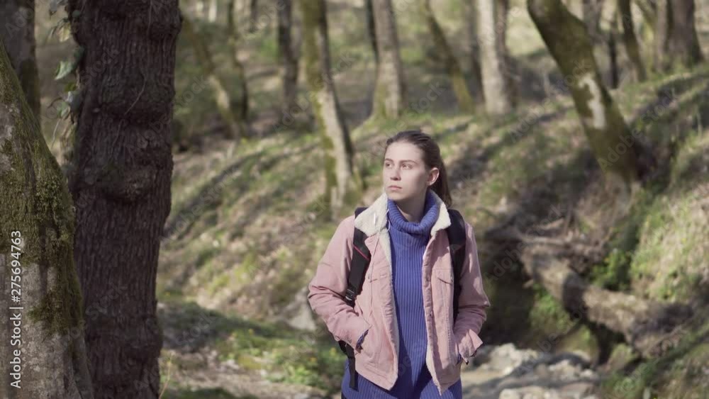Girl traveler with a backpack travels in the forest Girl traveler with a backpack travels in the forest