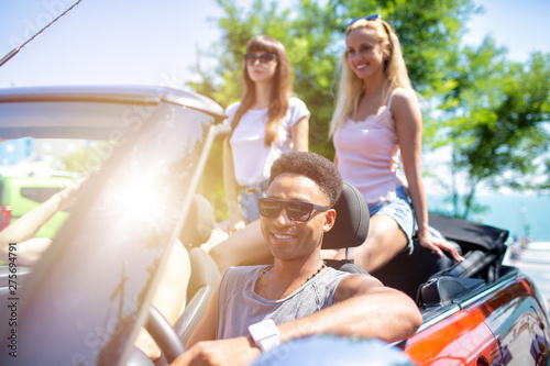 Young friends ready to travel by the car