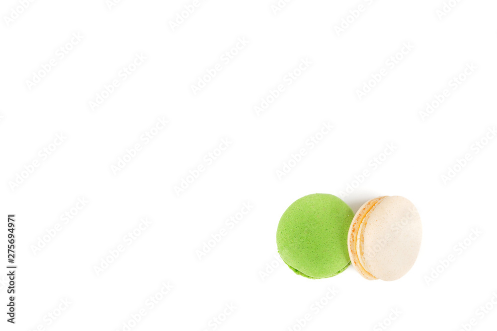Sweet fresh macaroons. Two macaroons lying on top of each other on a white background, green and white. Sweet fresh macaroons. Two macaroons lying on top of each other on a white background, green and white.