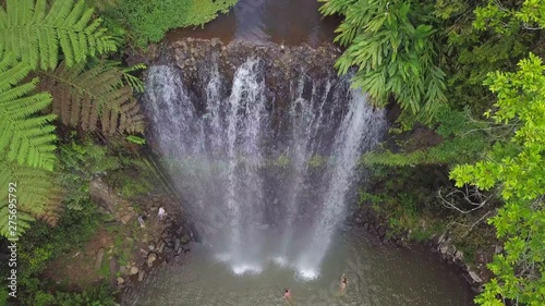 Aerial Descent: People Bathing Under Majestic Waterfall Among Lush Green, Atherton, Australia photo