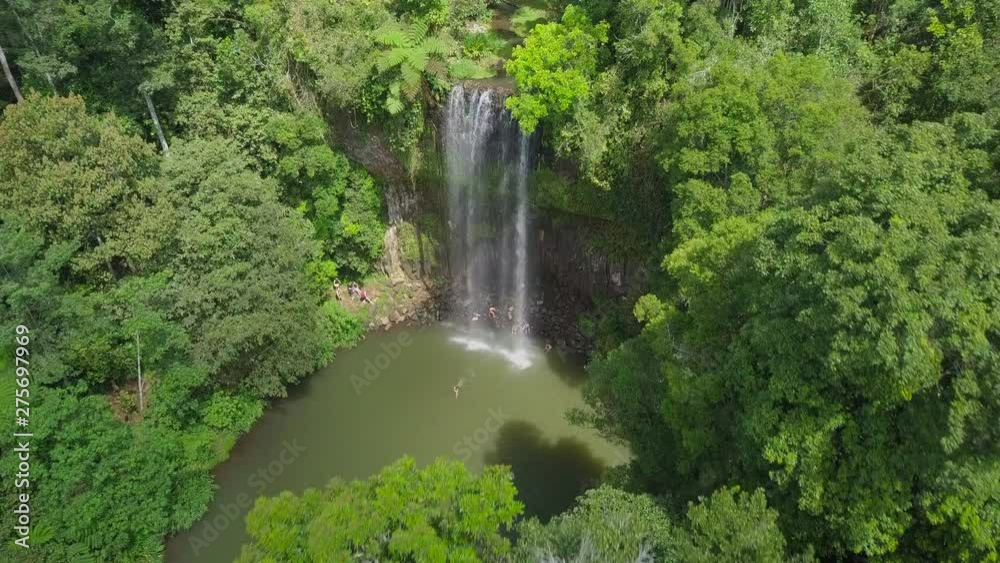 Aerial Forward: People Bathing Under Majestic Waterfall Among Lush Green, Atherton, Australia Aerial Forward: People Bathing Under Majestic Waterfall Among Lush Green, Atherton, Australia