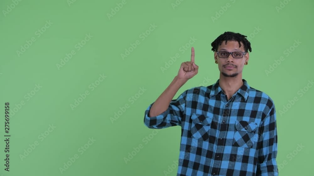 Happy young African hipster man pointing up and giving thumbs up Happy young African hipster man pointing up and giving thumbs up
