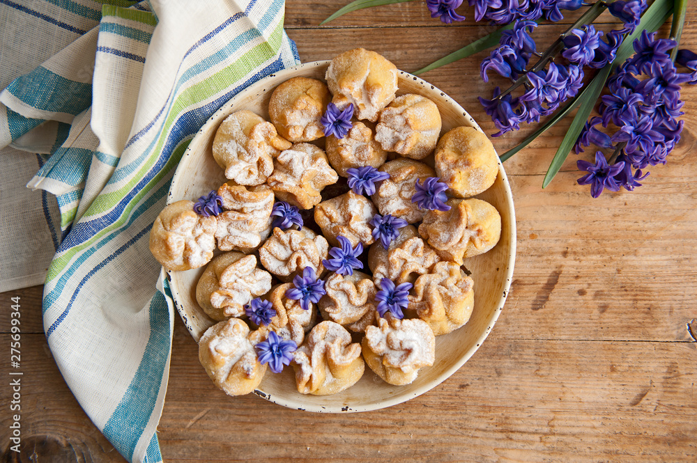 Homemade biscuit with violet hyacinth, white flower and yellow taraxacum on the wooden table Homemade biscuit with violet hyacinth, white flower and yellow taraxacum on the wooden table