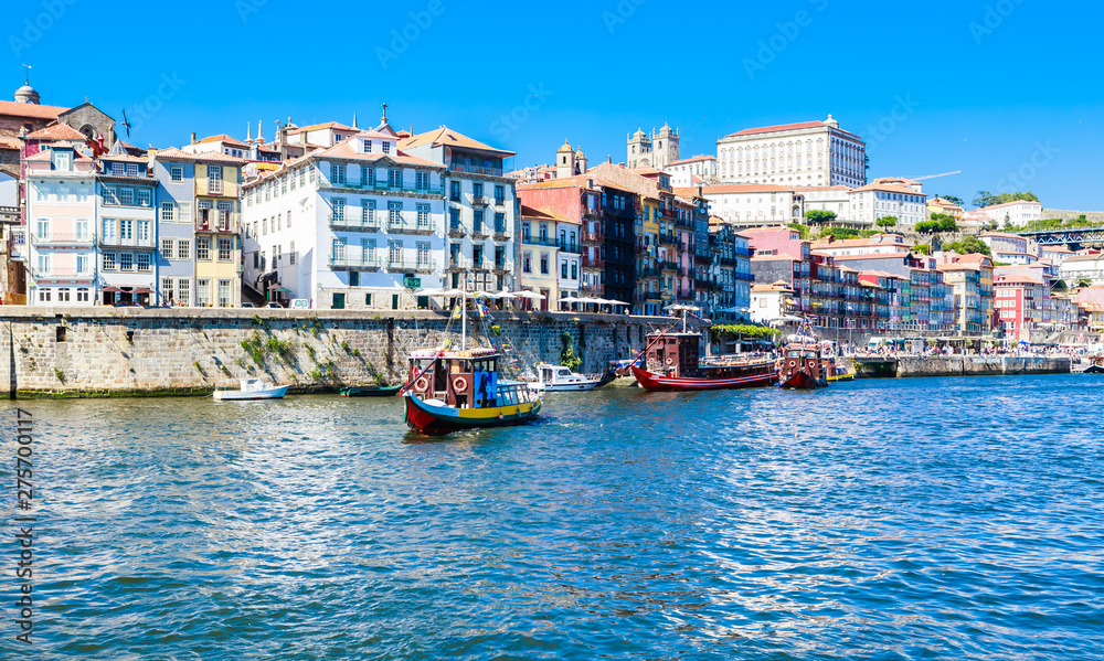 Boats in the river `douro with a view on Porto , Portugal.