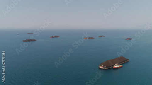 aerial view barges full coal anchored at sea near coal fired power station waiting be transported. coal barges and tugboats java, paiton indonesia © Alex Traveler