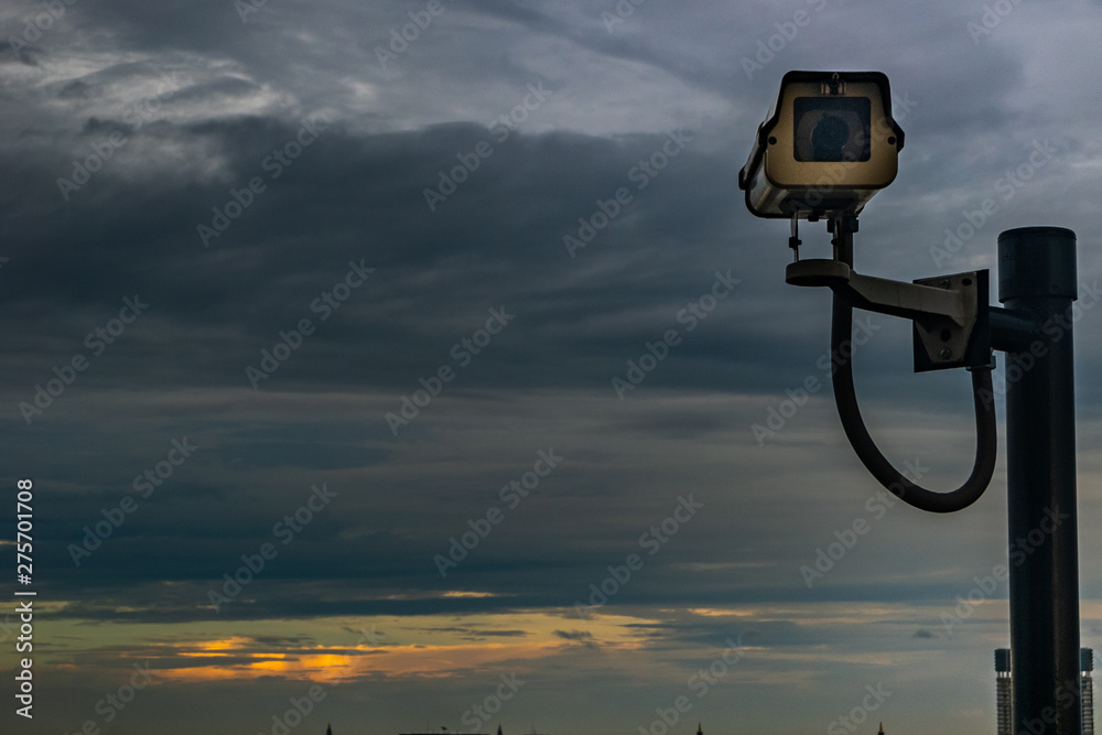 CCTV monitoring, security cameras. Backdrop with sky and clouds during beautiful twilight. CCTV monitoring, security cameras. Backdrop with sky and clouds during beautiful twilight.