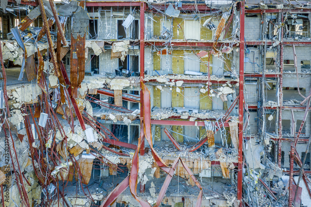 The inside of a demolished building with steel beams in disarray