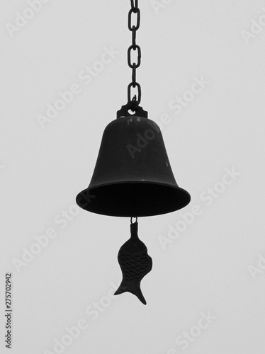 Black and white shot of Chinese bronze bell with the tongue in shape of fish