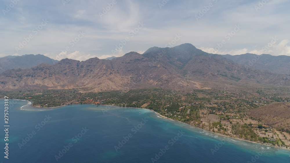 aerial tropical landscape town by sea, mountains, beach, boats on surface water. Bali,Indonesia, travel concept