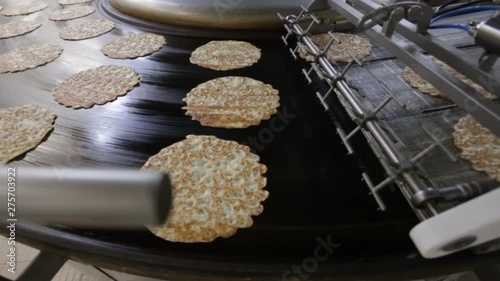 Rawpancakes on hot conveyor belt