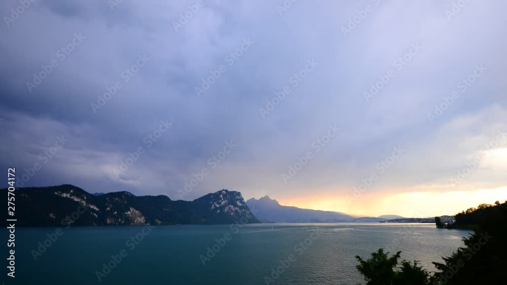 Magnificent panorama of mountains and lake in central Switzerland. Setting sun painted the clouds in the grand color. Time lapse. Magnificent panorama of mountains and lake in central Switzerland. Setting sun painted the clouds in the grand color. Time lapse.