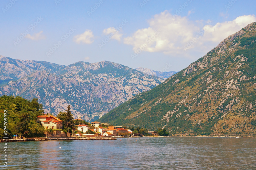 Fototapeta premium Summer vacations. Sunny landscape with sea, mountains and small seaside town. Montenegro, Adriatic Sea, Bay of Kotor, Prcanj