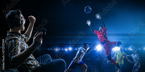 Young man playing football video game © Sergey Nivens