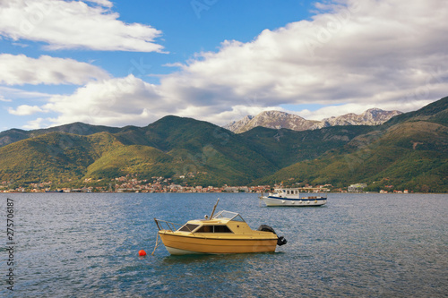 Beautiful autumn Mediterranean landscape - mountains, sea and fishing boats on the water. Montenegro, Adriatic Sea, Bay of Kotor