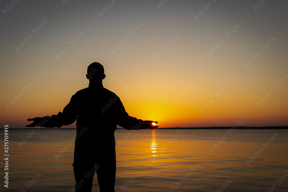 Person holding sun in palm of hands