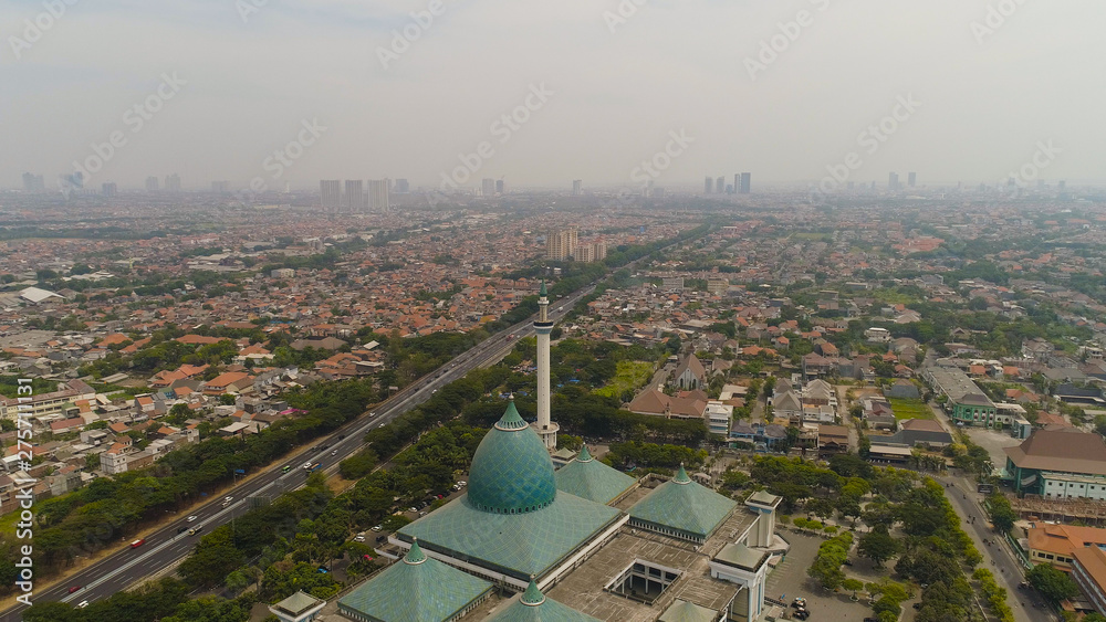 aerial view cityscape city Surabaya with mosque Al Akbar, highway, skyscrapers, buildings and houses. mosque in Indonesia Al Akbar in Surabaya, Indonesia. beautiful mosque with minarets on island Java