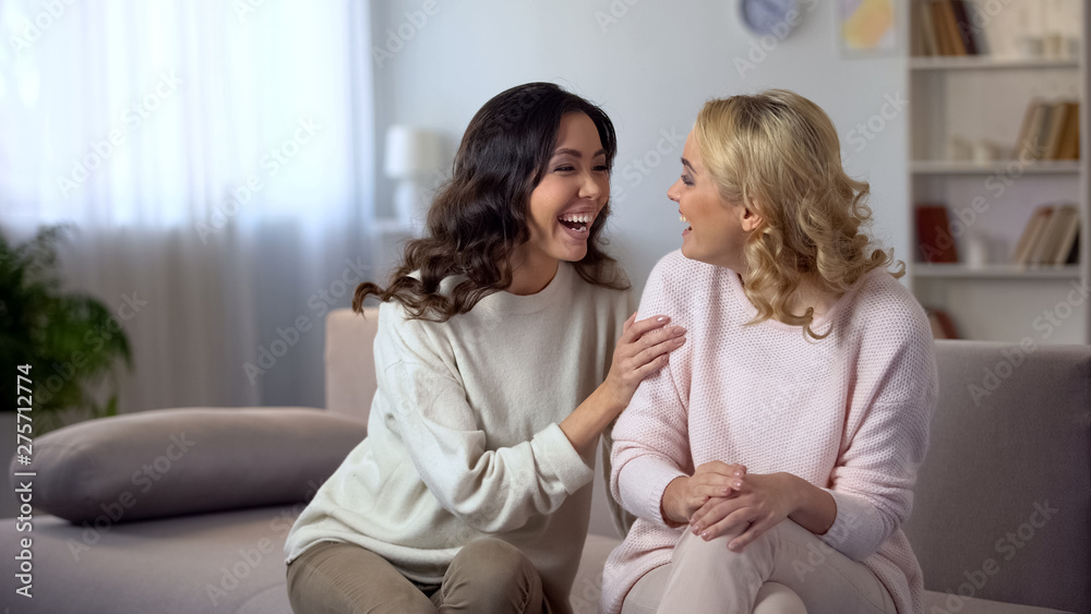 Cheerful female friends laughing at home, having fun together, relationship Cheerful female friends laughing at home, having fun together, relationship