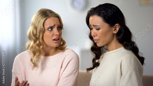 Upset young woman telling best friend about her boyfriend betrayal, compassion