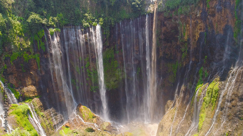 beautiful waterfall Coban Sewu in tropical forest, Java Indonesia. aerial view tumpak sewu waterfall in rainforest