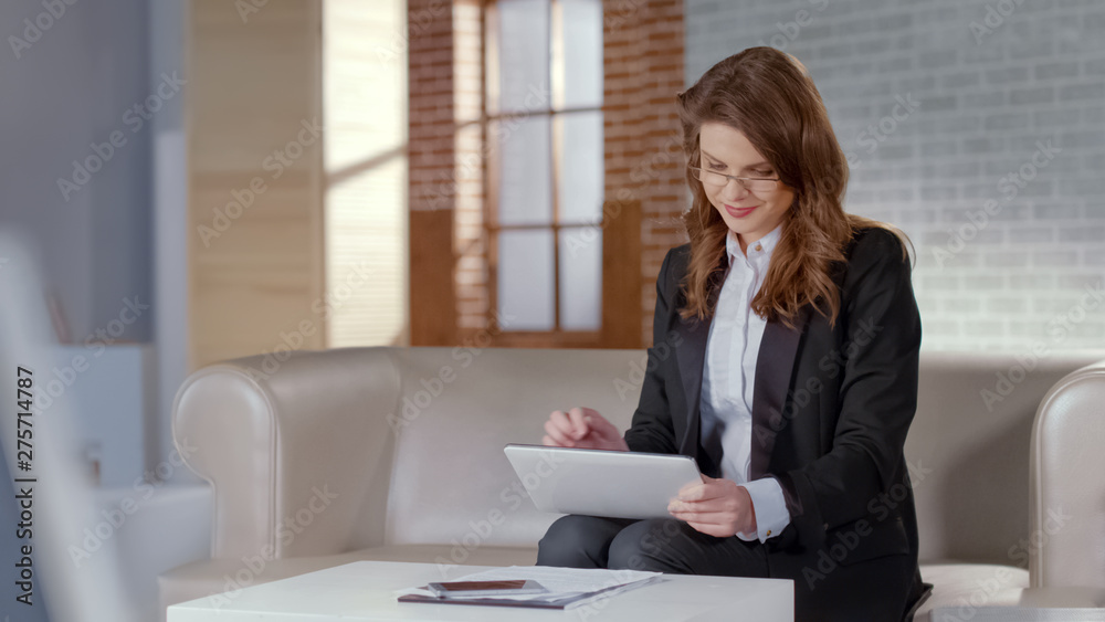 Positive lady using tablet for business or online courses, remote education