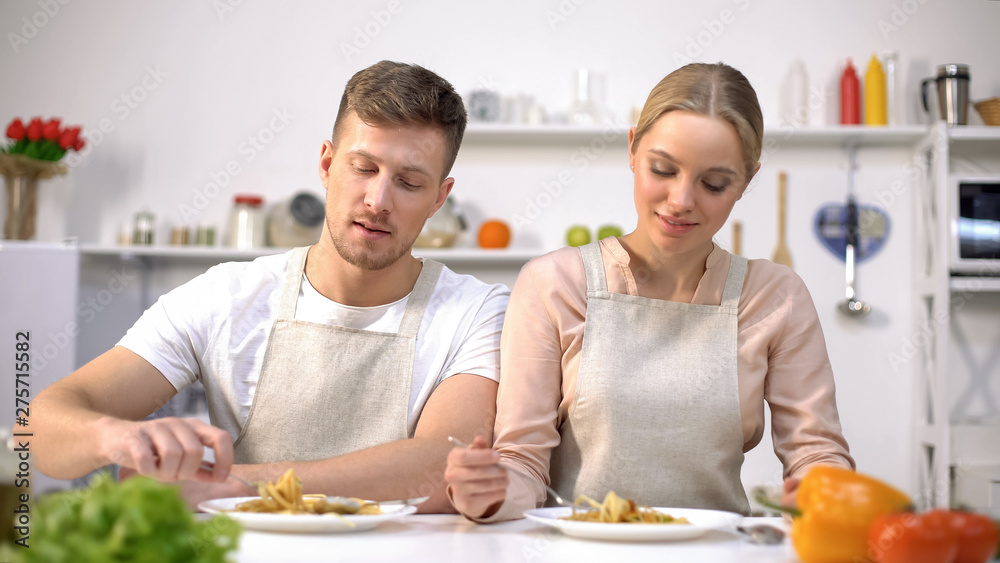 Nice couple eating pasta, Italian cuisine, family traditions, cooking courses