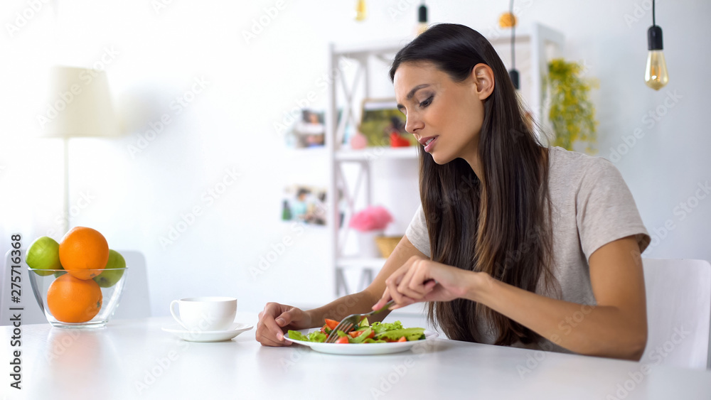 Pretty female eating salad, healthy vegetarian diet for weight loss, nutrition