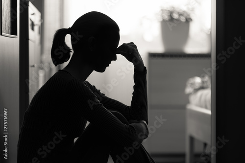 Quadro su tela Female sitting alone at home stressed with problems and worries.