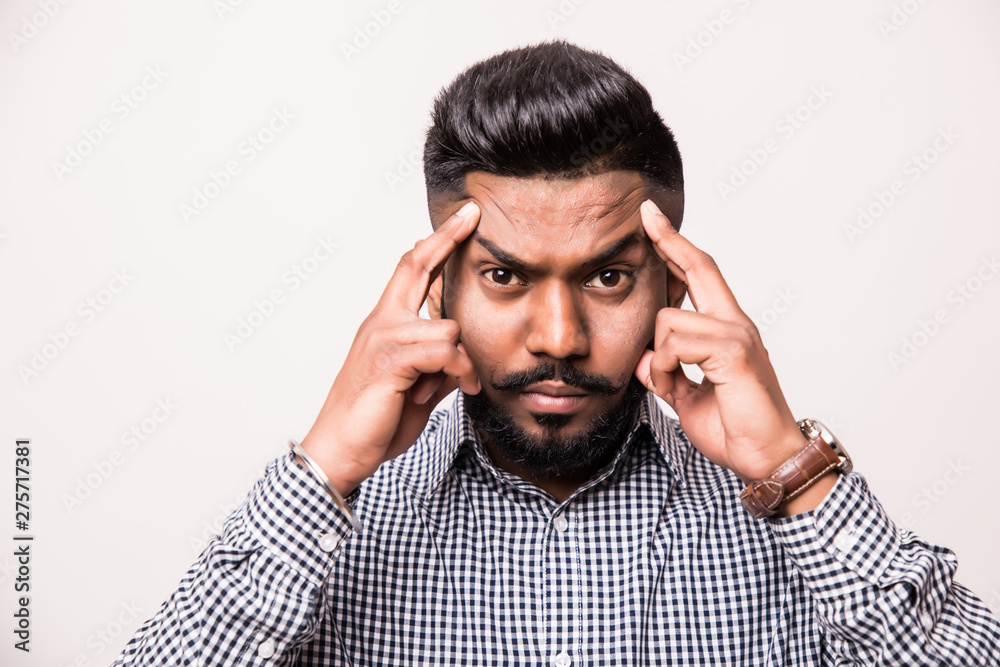 Pensive young indian man thinking isolated on white background Pensive young indian man thinking isolated on white background