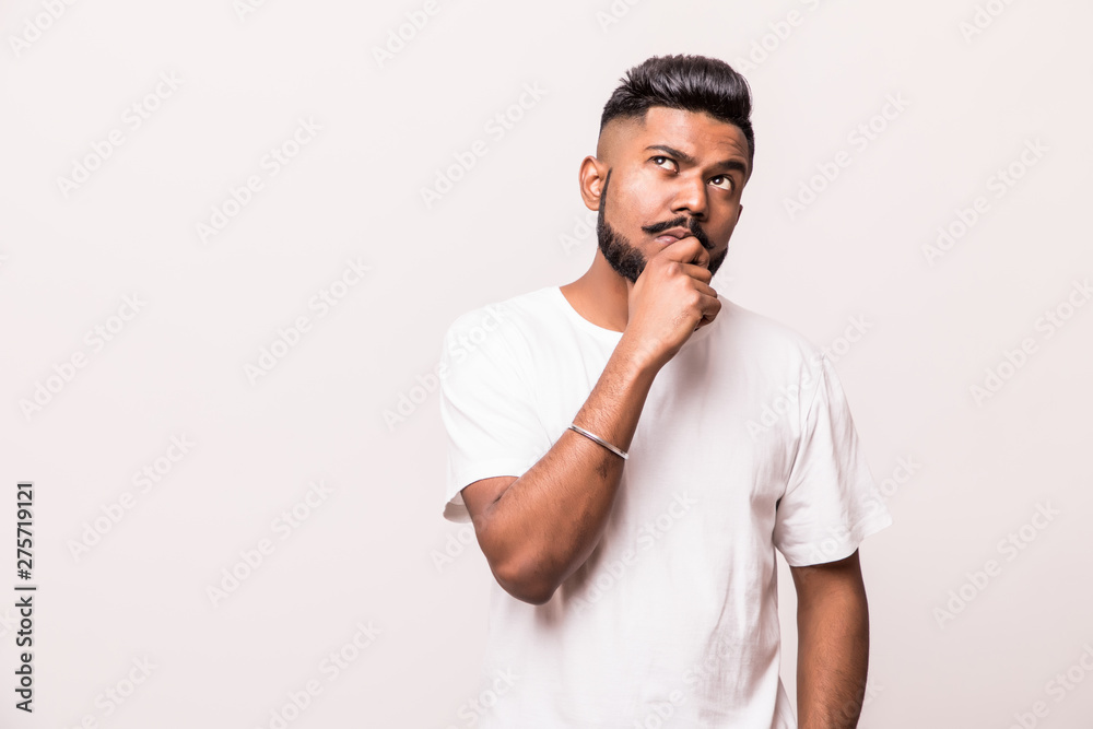 Impressed man with a confident look , putting his fingers under his chin, isolated on a white background. Impressed man with a confident look , putting his fingers under his chin, isolated on a white background.