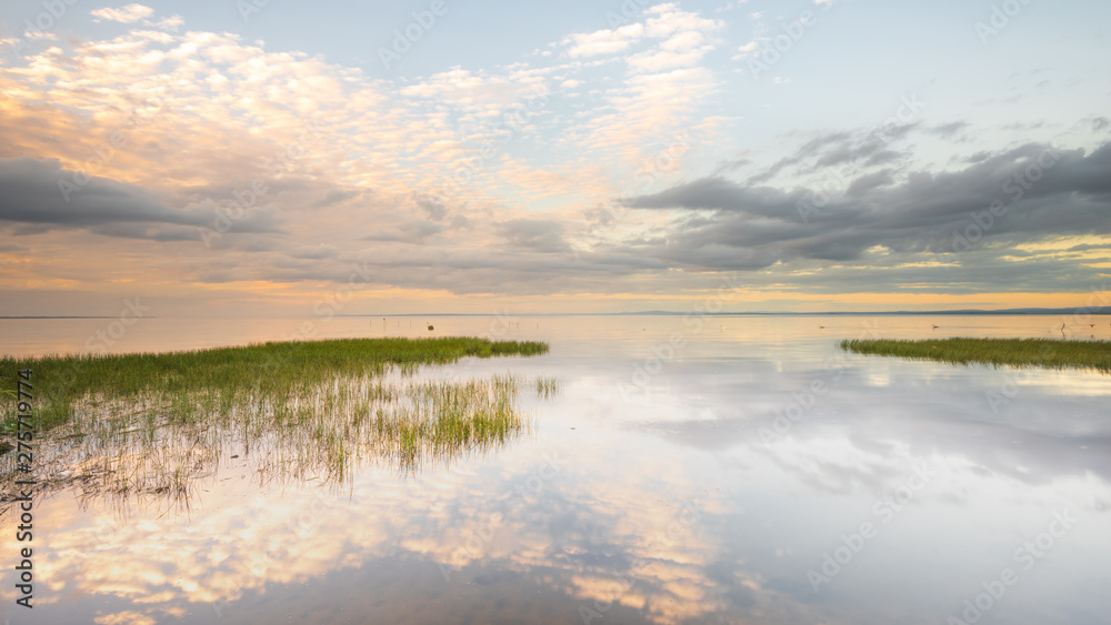Reflections on the becalmed waters of Lough Neagh, County Armagh, Northern Ireland 