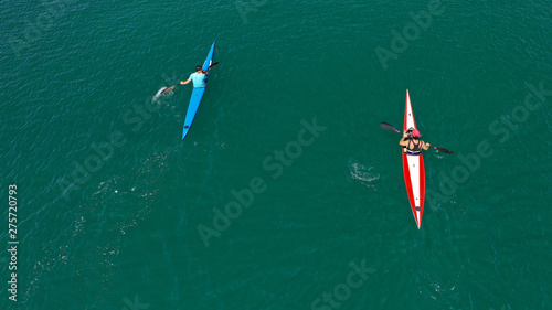 Aerial drone photo of young men competing with sport canoe in tropical lake with calm waters