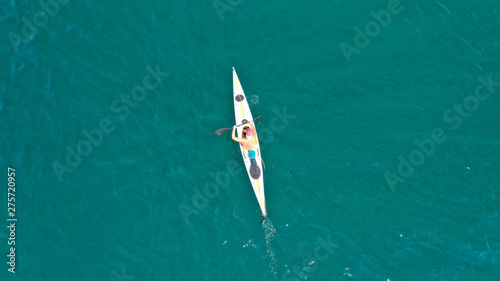 Aerial drone photo of fit man practising sport canoe in calm water sea © aerial-drone