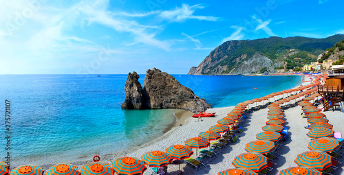 Fototapeta Naklejka Na Ścianę i Meble -  Panoramic view over colorful umbrellas at a beach in the Cinque Terre village of Monterosso