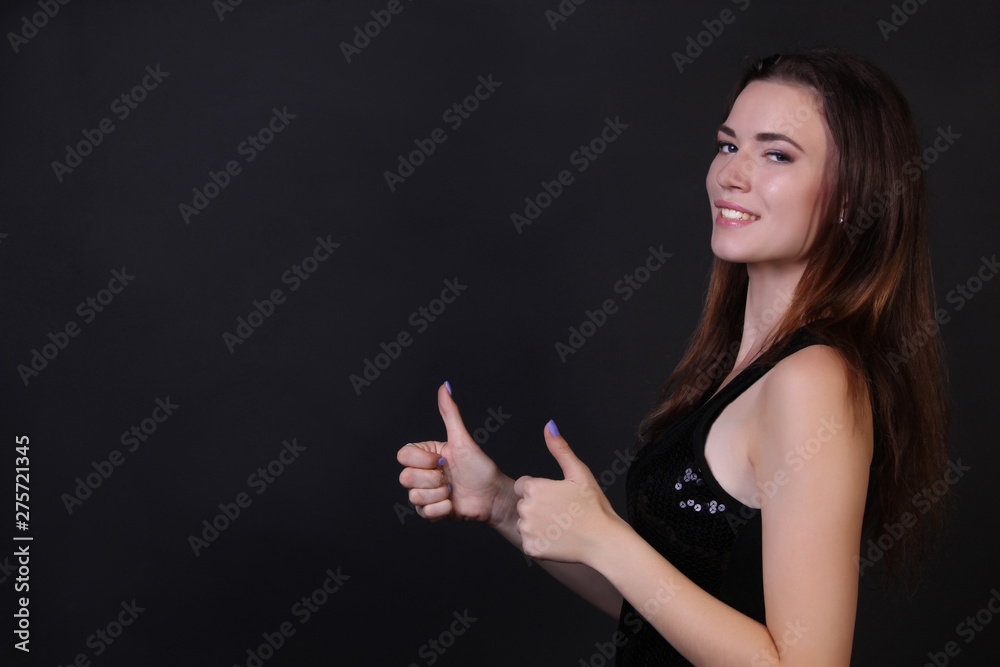 Beautiful portrait of a girl in a shiny vest on a black background photo for text Beautiful portrait of a girl in a shiny vest on a black background photo for text
