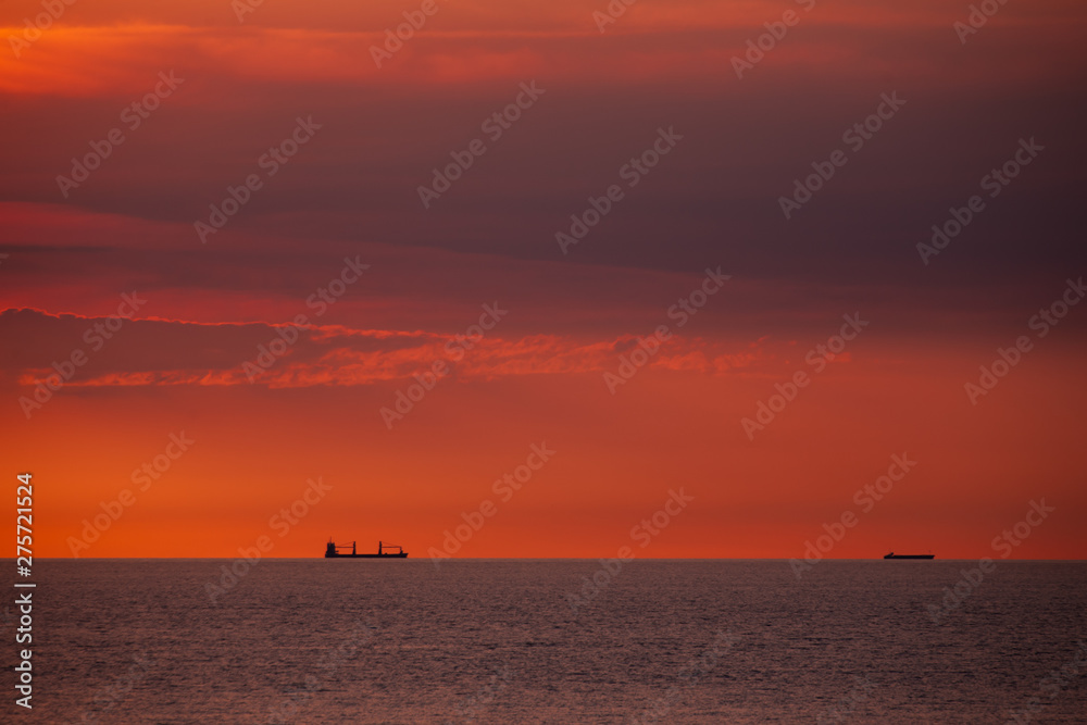 Cargo ships on a ship route on the open sea in the evening light. Cargo ships on a ship route on the open sea in the evening light.