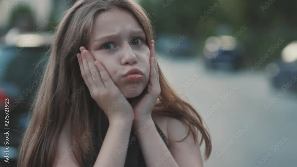 Shocked little girl looking at camera. Big eyes. Beautiful female teenager Close-up. Summertime. Blurred background. Emotions. Concept, idea, Caucasian, Slavic, Ukrainian, friendly, amicable Shocked little girl looking at camera. Big eyes. Beautiful female teenager Close-up. Summertime. Blurred background. Emotions. Concept, idea, Caucasian, Slavic, Ukrainian, friendly, amicable