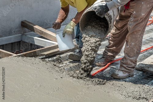 Pouring concrete at a construction site. Filling a rooftop with cement over the pipelines
