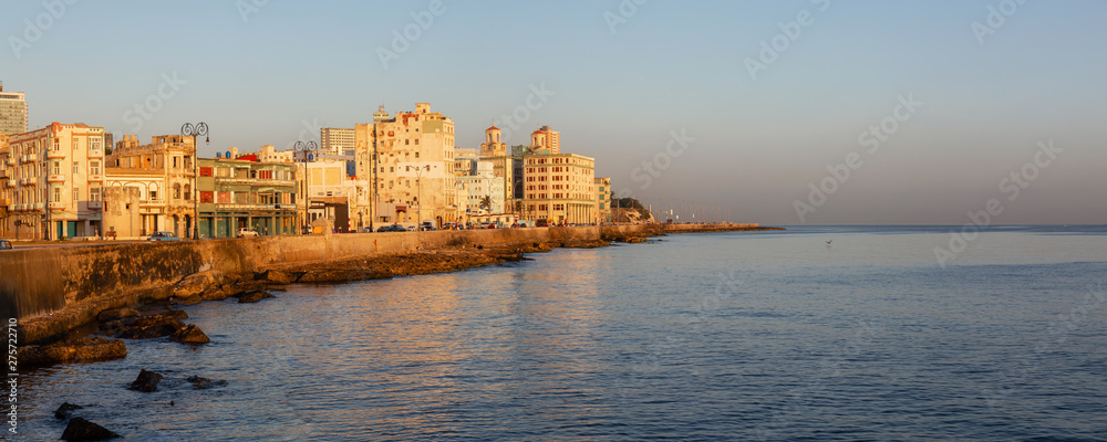 Fototapeta premium Beautiful panoramic view of the Old Havana City, Capital of Cuba, by the Ocean Coast during a vibrant sunny sunrise.