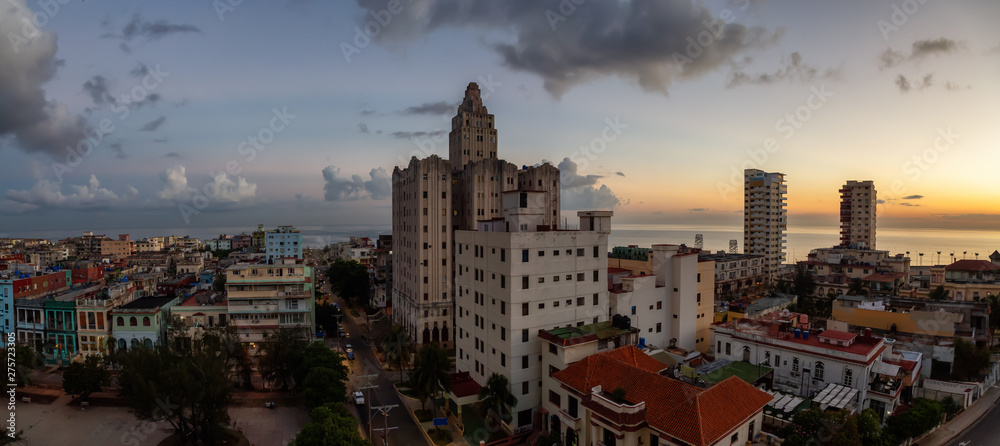 Naklejka premium Aerial Panoramic view of the Havana City, Capital of Cuba, during a colorful cloudy sunrise.